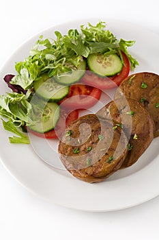 Seitan with vegetables isolated on white background. Fake meat.