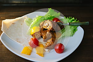 Seitan on white plate with the vegetables