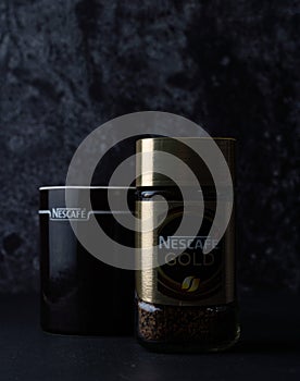 Selangor, Malaysia - April 2020: Nescafe gold instant coffee in a jar with black cup over dark background