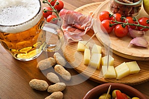Select appetizer with beer mug on wooden table