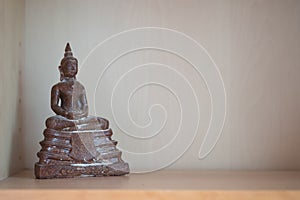 Select focus of ancient buddhas statue on buddha shelf