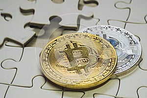 select focus close up a golden and silver bitcoin coin. cryptocurrency. Missing jigsaw puzzle pieces. Business concept.