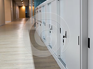 Select focus for key. White Cabinet for document storage. The keys are plugged into the filing cabinet. The filing cabinet is loca