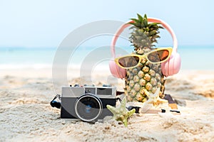 Select focus. Summer in the party. Hipster Pineapple Fashion in sunglass and listen music