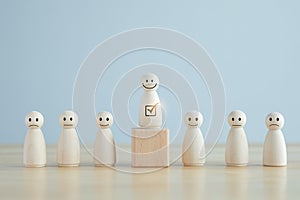 Select happy face wooden figure. Human Resources management choosing positive attitude to team leader concept.