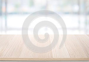 Select tive focus.Empty wood table top on blur abstract window glass background