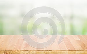 Select tive focus.Empty wood table top on blur abstract window glass background