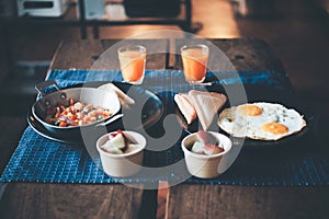 Selected Focus,Breakfast on wood table with sandwich, fried egg and orange