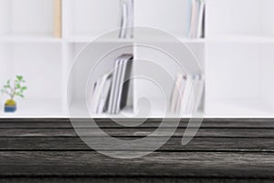 Selected focus empty black wooden table and Library or Bookstor