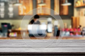 Selected focus empty brown wooden table and Coffee shop or restaurant blur background with bokeh image. for your photomontage or