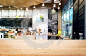 Selected focus empty brown wooden table and Coffee shop or restaurant blur background with bokeh image. for your photomontage or