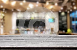 Selected focus empty brown wooden table and Coffee shop or restaurant blur background with bokeh image. for your photomontage or