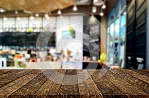 Selected focus empty brown wooden table and Coffee shop or restaurant blur background with bokeh image. for your photomontage or