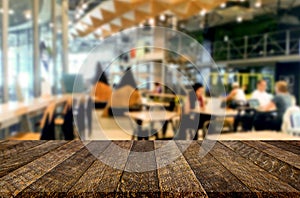 Selected focus empty brown wooden table and Coffee shop or restaurant blur background with bokeh image. for your photomontage or