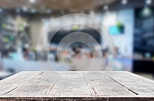 Selected focus empty brown wooden table and Coffee shop or restaurant blur background with bokeh image. for your photomontage or