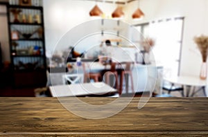 Selected focus empty brown wooden table and Coffee shop or restaurant blur background with bokeh image. for your photomontage or