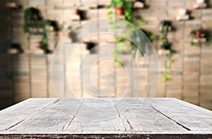 Selected focus empty brown wooden table and Coffee shop or restaurant blur background with bokeh image. for your photomontage or