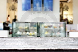 Selected focus empty brown wooden table and Coffee shop or restaurent blur background with bokeh image. for your photomontage or