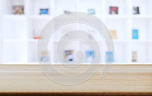 Selected focus empty old wooden table and .Library or Bookstore blur background with bokeh image. for your photomontage or product