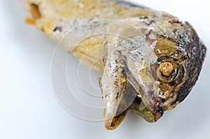 Selected focus of a head of fried mackerel on white background