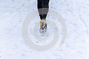 Selected focus. Person running in the snow. Concept of skiers. Running, trail, climbing, winter crossing