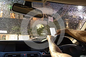 Selected focus on rain water on windshield man driving car and u