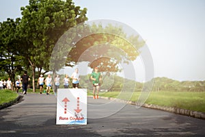 Selected focus on running sign group of people jogging in the pa