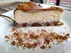 Selected focused slices of Biscoff Cheesecake are placed on a white plate.
