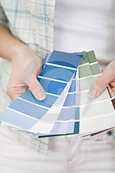 Selecting paint colour for new home. Conceptual image