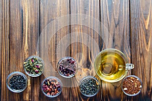 Selection of assorted teas in transparent little bowls on natural background