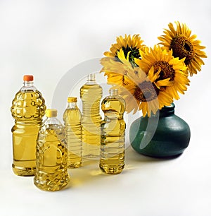 A selection of bottles of sunflower oil and a bouquet of sunflowers