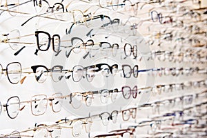 Selection of branded eyeglasses in an optician retail shop in Poland.