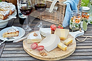 Selection of cheese on a cheeseboard at a picnic photo