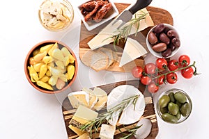 Selection of cheeses served together with olives, baby and sun dried tomatoes