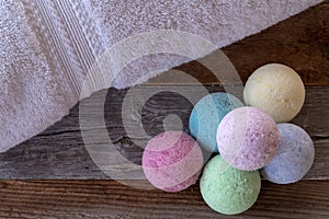 Selection of colorful bath bombs on weathered wood.