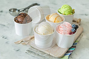 Selection of colorful ice cream scoops in paper cones