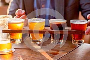 Selection of craft beers in a flight ready for tasting