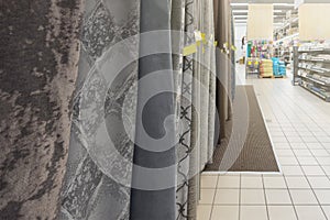Selection of curtains in the store. Curtains of different shades hang in the store. Purchase and selection of various