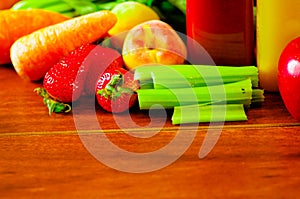 Selection of delicious fruits and vegetables spread out on wooden surface, beautiful colors, healthy lifestyle concept