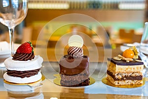 Selection of desserts: amandine, meringue with chocolate and strawberries, caramel cake