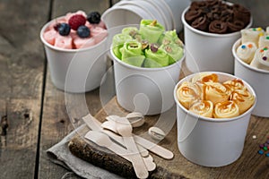 Selection of different rolled ice creams in cone cups