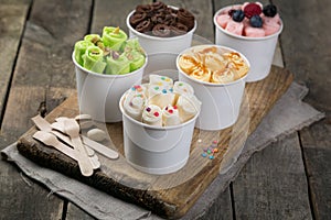 Selection of different rolled ice creams in cone cups