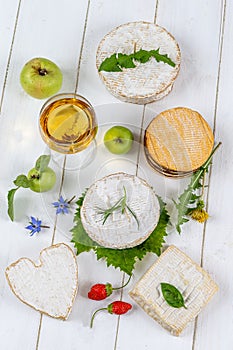 Selection of different types of cheese. Tasty and fresh cheese, with glass of wine, wooden background top wiew