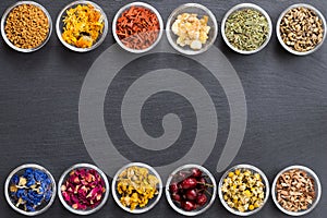 Selection of dried herbs on a dark background with copy space, t