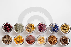 Selection of dried herbs on a white background with copy space,