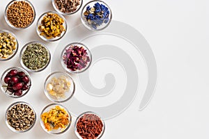 Selection of dried herbs on a white background with copy space,