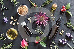 Selection of essential oils and herbs on a dark background