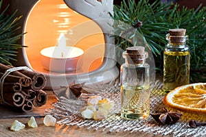 Selection of essential oils with star anise, cinnamon, frankincense, clove, dried orange