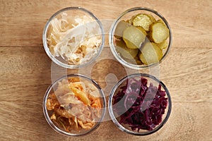 Selection of fermented foods - kimchi, purple and white sauerkrau and gherkins