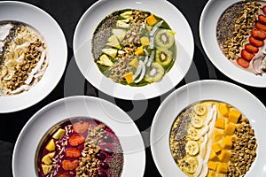 A selection of five different Smoothie bowl with different fruits, yogurt, granola and nut seeds